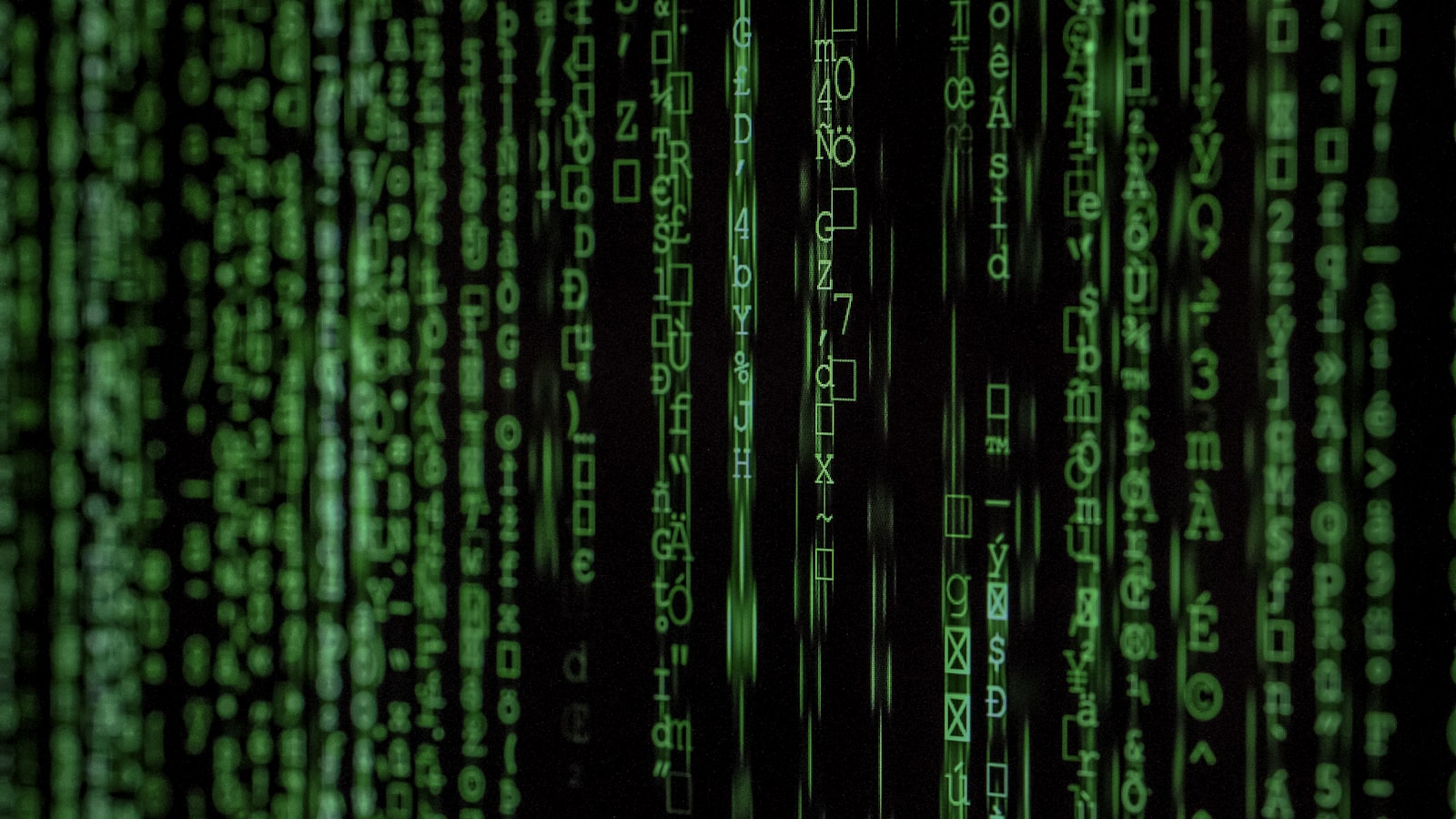 Streams of glowing blue digital data flowing across a dark screen