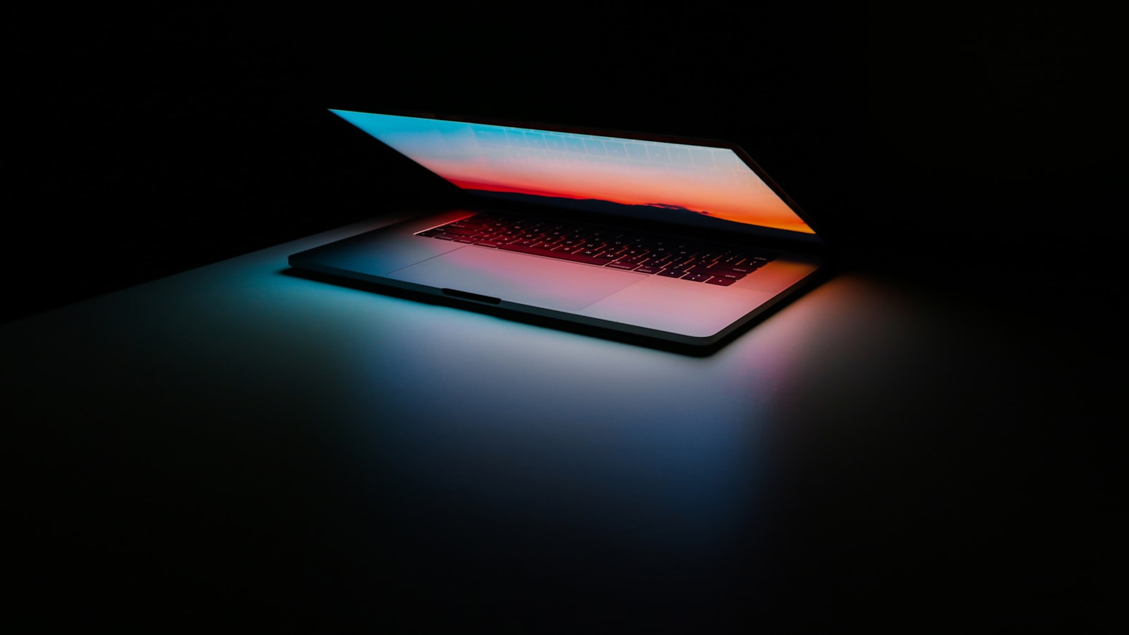 An open laptop on a desk beside papers, ready for scanning and signing