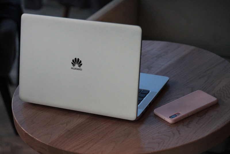 A person reading an email on a laptop with a suspicious warning symbol